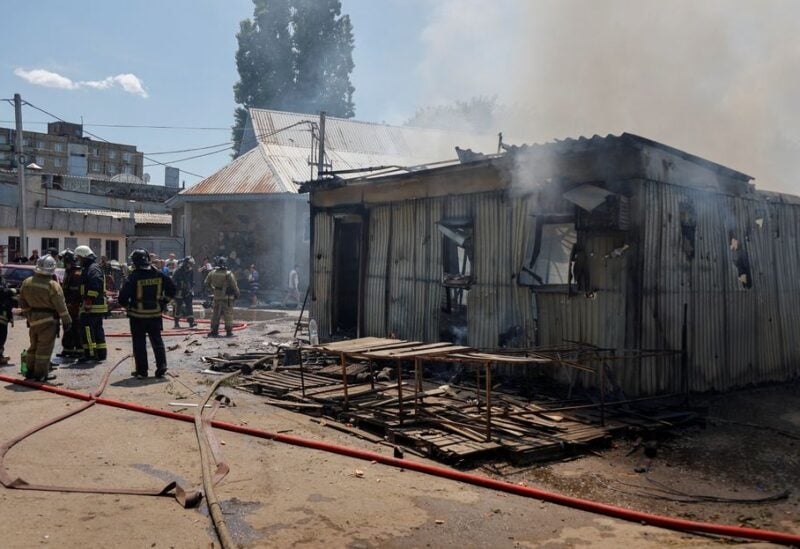 Firefighters gather near a destroyed building at the central Maisky market following recent shelling in the course of Ukraine-Russia conflict in Donetsk, Ukraine June 13, 2022. REUTERS/Stringer