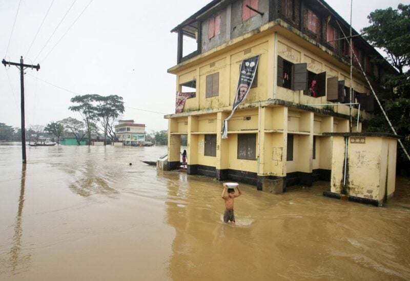 A boy wades through a flooded area during a widespread flood in the northeastern part of the country, in Sylhet, Bangladesh, June 19, 2022. REUTERS/Stringer
