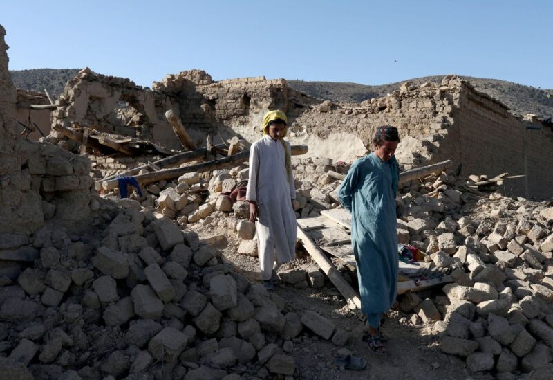 Afghan people walk through the debris of damaged houses after the recent earthquake in Wor Kali village in the Barmal district of Paktika province, Afghanistan, June 25, 2022. REUTERS/Ali Khara