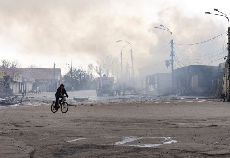 A man rides on a bicycle in front of a building after it was hit by shelling in Lysychansk, Luhansk region, Ukraine, April 16, 2022. REUTERS/Marko Djurica