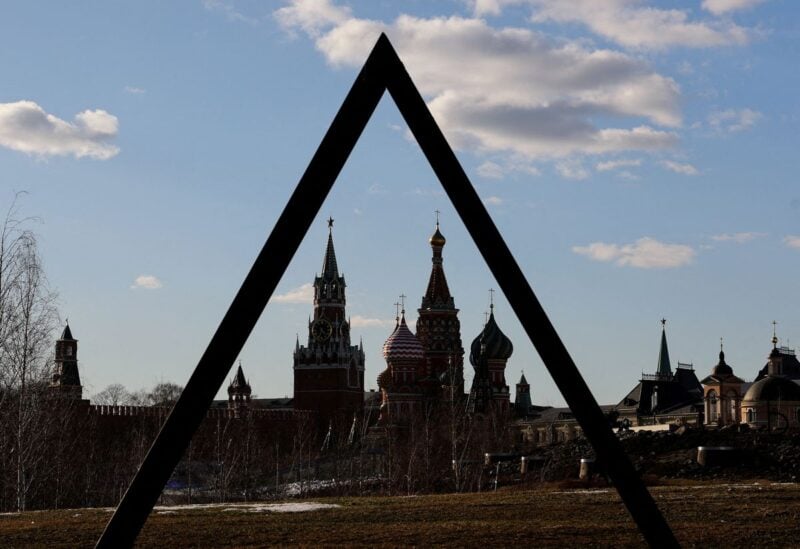 The Kremlin's Spasskaya Tower and St. Basil's Cathedral are seen through the art object in Zaryadye park in Moscow, Russia March 15, 2022. REUTERS/Evgenia Novozhenina/File Photo