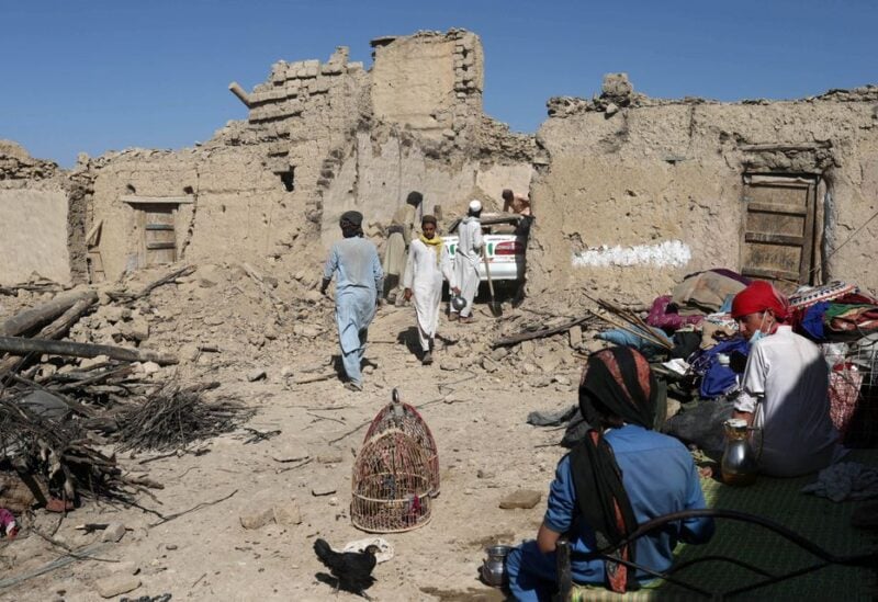 Afghan men try to retrieve a car from the debris of damaged houses after the recent earthquake in Wor Kali village in the Barmal district of Paktika province, Afghanistan, June 25, 2022. REUTERS/Ali Khara