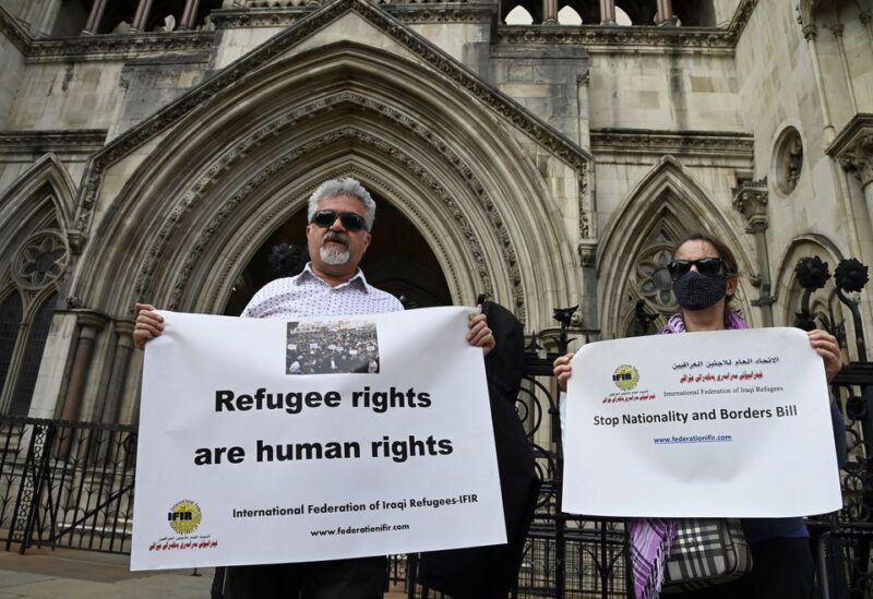 Demonstrators protest outside the Royal Courts of Justice whilst a legal case is heard over halting a planned deportation of asylum seekers from Britain to Rwanda, London, Britain, June 10, 2022. REUTERS/Toby Melville