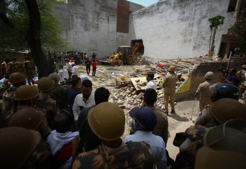 A bulldozer demolishes the house of a Muslim man that Uttar Pradesh state authorities accuse of being involved in riots last week, that erupted following comments about the Prophet Mohammed by India's ruling Bharatiya Janata Party (BJP) members, in Prayagraj, India, June 12, 2022. Authorities claim the house was illegally built. REUTERS/Ritesh Shukla