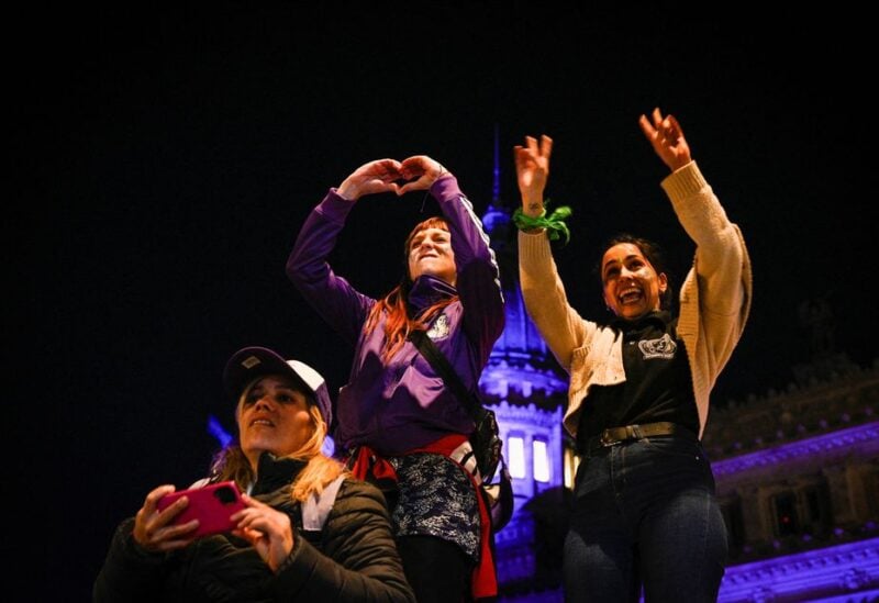 Women of the movement "Not one (woman) less" gesture outside the Congress to protest against femicides