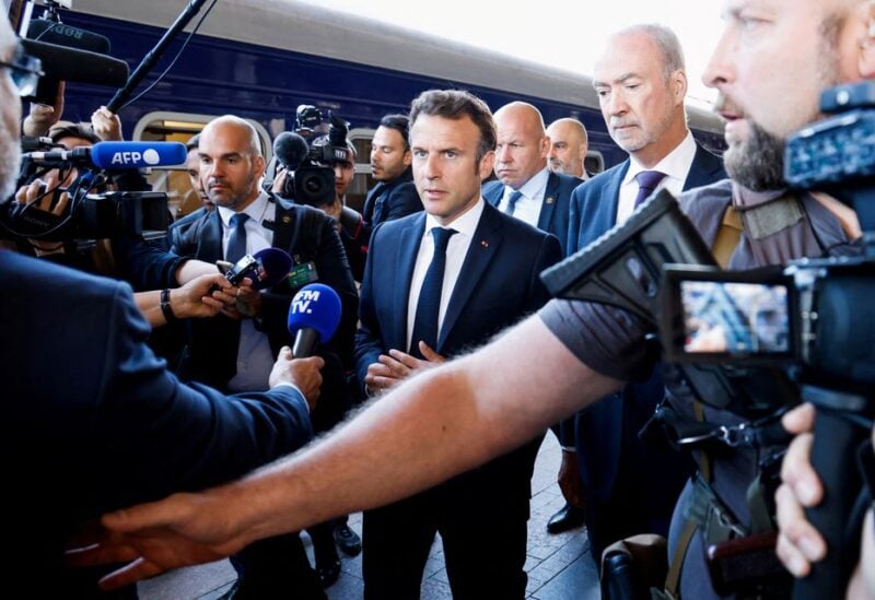 French President Emmanuel Macron speaks to journalists as he arrives at the train station in Kyiv, Ukraine