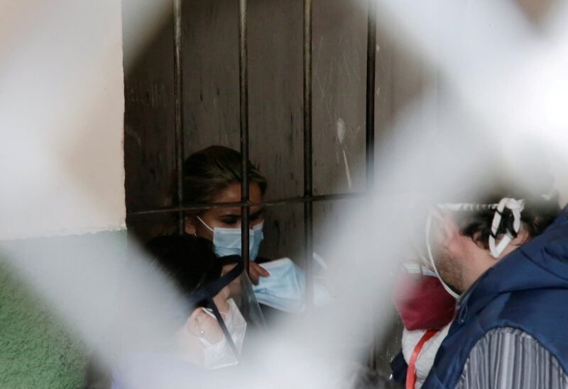FILE PHOTO: Bolivia's former interim President Jeanine Anez holds a protective face mask as she is detained at a FELCC (Special Force to fight against Crime) prison in La Paz, Bolivia, March 13, 2021. REUTERS/David Mercado/File Photo