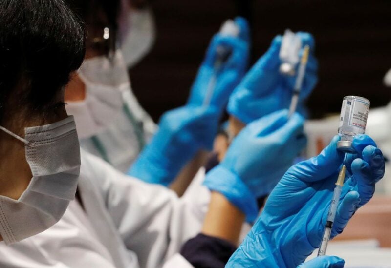 Healthcare workers prepare doses of the Moderna coronavirus disease (COVID-19) vaccine before administering them to staffers of Japan's supermarket group Aeon at the company's shopping mall in Chiba, Japan June 21, 2021. REUTERS/Kim Kyung-Hoon