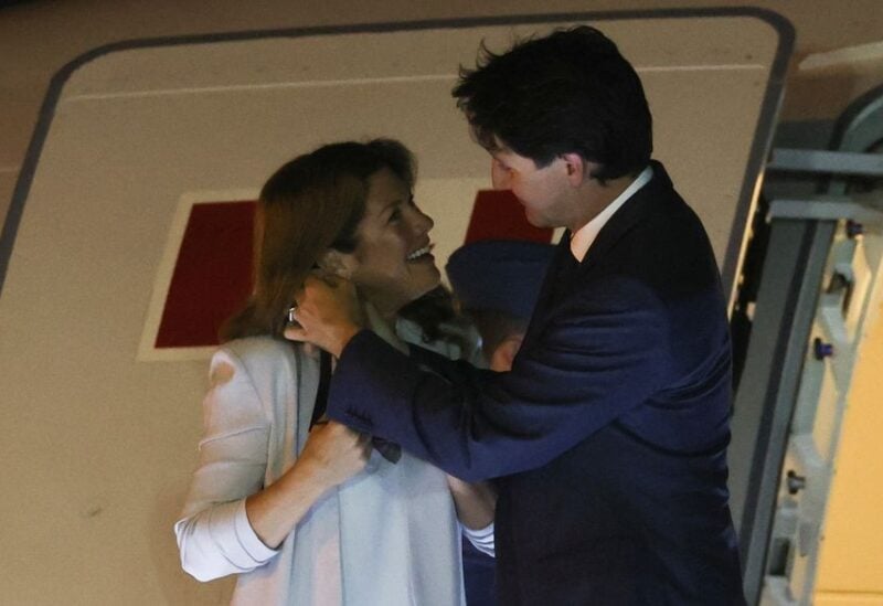 Canada's Prime Minister Justin Trudeau removes his wife Sophie Gregoire Trudeau's mask as they arrive at Los Angeles International Airport to attend the ninth Summit of the Americas in Los Angeles, California, U.S., June 7, 2022. REUTERS/Mike Blake