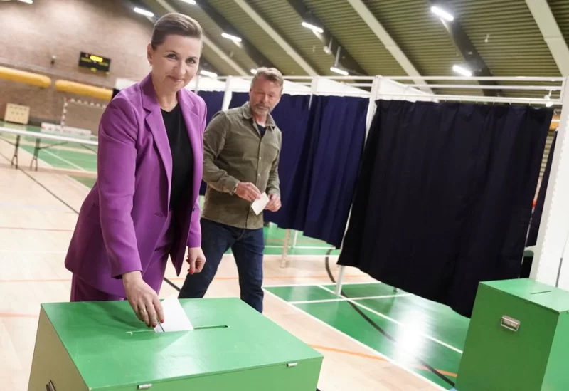Danish Prime Minister Mette Frederiksen and her husband Bo Tengberg vote at Hareskovhallen