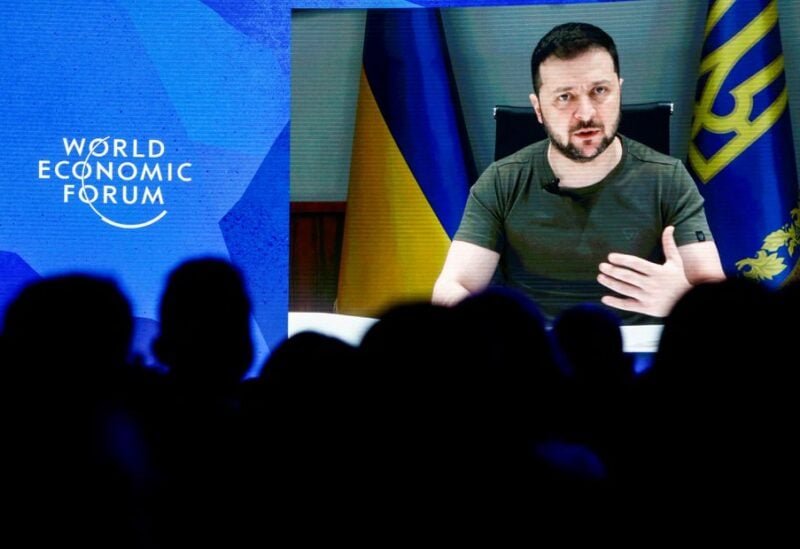 Ukrainian President Volodymyr Zelenskiy is seen on a screen as he delivers a video address to the delegates of the World Economic Forum (WEF) in Davos, Switzerland May 23, 2022. REUTERS/Arnd Wiegmann