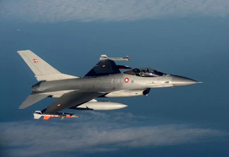 A Danish F16 fighter jet demonstrates the interception of a Belgian air force transport plane