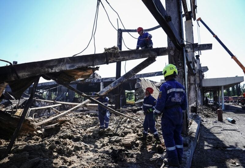 Rescuers work at a site of a shopping mall hit by a Russian missile strike, as Russia's attack on Ukraine continues, in Kremenchuk, in Poltava region, Ukraine June 28, 2022. REUTERS/Anna Voitenko