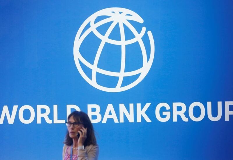 A participant stands near a logo of World Bank at the International Monetary Fund - World Bank Annual Meeting 2018 in Nusa Dua, Bali, Indonesia, October 12, 2018. REUTERS/Johannes P. Christo/File Photo