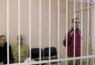 FILE PHOTO: FILE PHOTO: A still image, taken from footage of the Supreme Court of the self-proclaimed Donetsk People's Republic, shows Britons Aiden Aslin, Shaun Pinner and Moroccan Brahim Saadoun captured by Russian forces during a military conflict in Ukraine, in a courtroom cage at a location given as Donetsk, Ukraine, in a still image from a video released June 8, 2022. Video taken June 8, 2022. Supreme Court of Donetsk People's Republic/Handout via REUTERS TV/File Photo