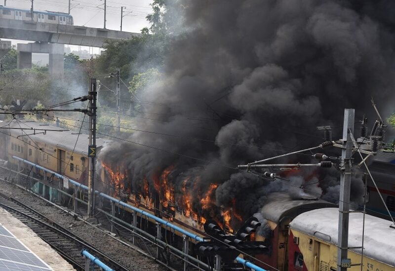 Smoke billows out from a passenger train coach after it was set on fire by protestors during a protest against "Agnipath scheme" for recruiting personnel for armed forces, in Secunderabad in the southern state of Andhra Pradesh, India, June 17, 2022. REUTERS/Stringer NO ARCHIVES. NO RESALES