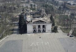 FILE PHOTO: A view shows the building of a theatre destroyed in the course of Ukraine-Russia conflict, as a word "children" in Russian is written in large white letters on the pavement, in the southern port city of Mariupol, Ukraine April 10, 2022. Picture taken with a drone. REUTERS/Pavel Klimov/File Photo