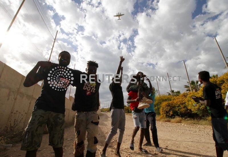 A group of migrants make their way to the Temporary Immigration Center (CETI) as they celebrate crossing the Melilla fence.