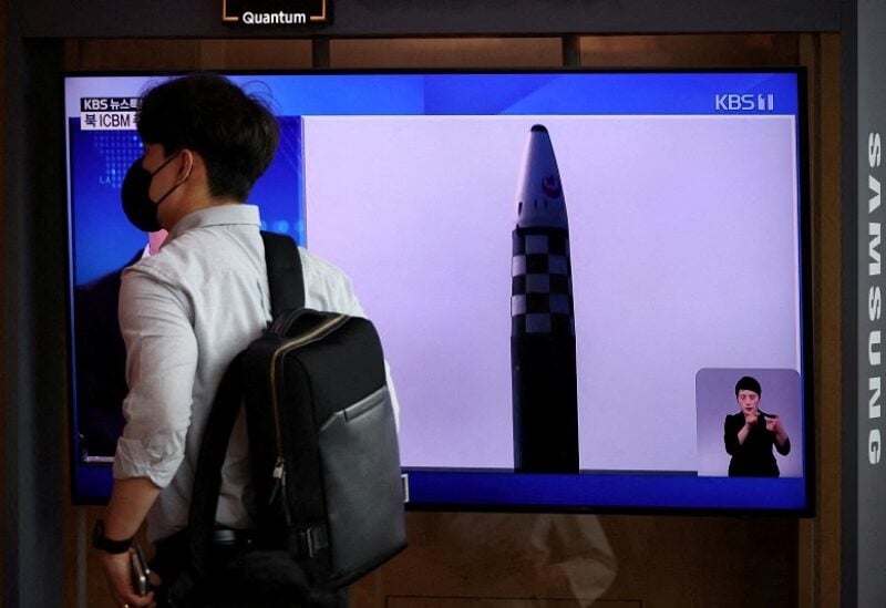 FILE PHOTO: A man walks past a TV broadcasting a news report on North Korea's launch of three missiles including one thought to be an intercontinental ballistic missile (ICBM), in Seoul, South Korea, May 25, 2022. REUTERS/Kim Hong-Ji/File Photo