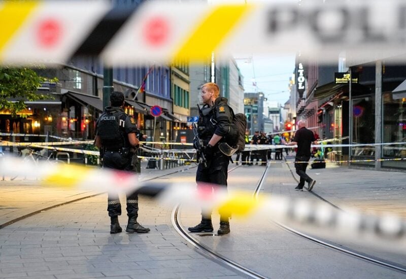 Security forces stand at the site where several people were injured during a shooting outside the London pub in central Oslo, Norway June 25, 2022. Javad Parsa/NTB/via REUTERS ATTENTION EDITORS - THIS IMAGE WAS PROVIDED BY A THIRD PARTY. NORWAY OUT. NO COMMERCIAL OR EDITORIAL SALES IN NORWAY.