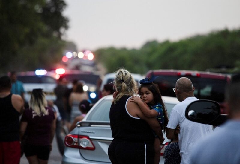 Rose Perez holds her mother Scarlet Chavez at the scene where people were found dead inside a trailer truck in San Antonio, Texas, U.S. June 27, 2022. REUTERS/Kaylee Greenlee Beal