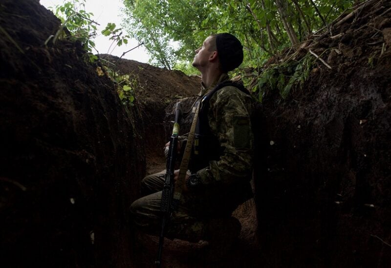 A Ukrainian serviceman sits in a trench at a position, as Russia's attack on Ukraine continues, in Luhansk region, Ukraine June 18, 2022. REUTERS/Anna Kudriavtseva
