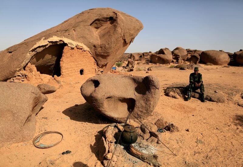 FILE PHOTO: A Polisario fighter sits on a rock at a forward base on the outskirts of Tifariti, Western Sahara, September 9, 2016. REUTERS/Zohra Bensemra/File Photo