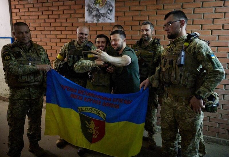 Ukraine's President Volodymyr Zelenskiy poses for a picture with Ukrainian service members as he visits their position, while Russia's attack on Ukraine continues, in Soledar, Donetsk region, Ukraine June 5, 2022. Picture taken June 5, 2022. Ukrainian Presidential Press Service/Handout via REUTERS