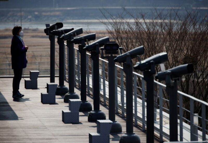 A woman looks toward the north at an observatory platform near the demilitarized zone separating the two Koreas in Paju, South Korea, March 24, 2021. REUTERS/Kim Hong-Ji