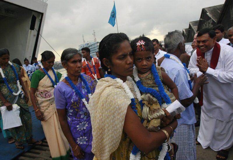 An ethnic minority Tamil woman arrives with her daughter to go to her native village after arriving from India on a passenger ferry at a Colombo port October 12, 2011. According to a press release from the U.N., they are among the first group of 37 refugees who are returning to the island nation after escaping to India 20 years ago due to a 25-year civil war between the government's military and the Liberation Tigers of Tamil Eelam (LTTE). REUTERS/Dinuka Liyanawatte