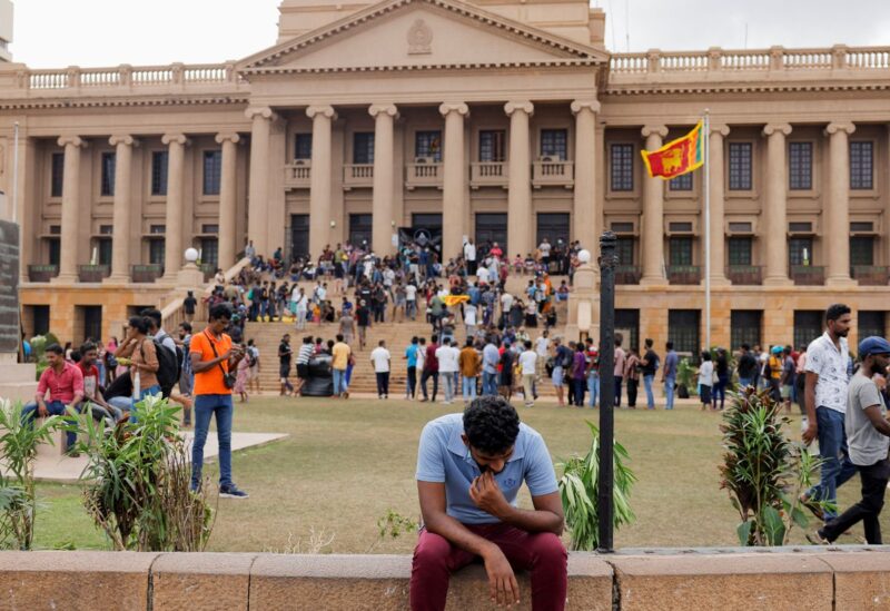 A demonstrator rests after entering the Presidential Secretariat premises, after President Gotabaya Rajapaksa fled, amid the country's economic crisis, in Colombo, Sri Lanka July 10, 2022. REUTERS/Dinuka Liyanawatte