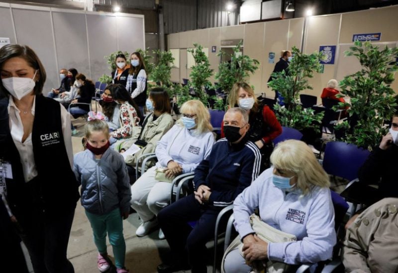 Ukrainian families sit as they are helped by members of the Spanish Commission for Refugee Aid (CEAR) after they arrived as refugees to Spain from Ukraine, at a Ukrainian refugees reception centre in Malaga, southern Spain, April 20, 2022. REUTERS/Jon Nazca