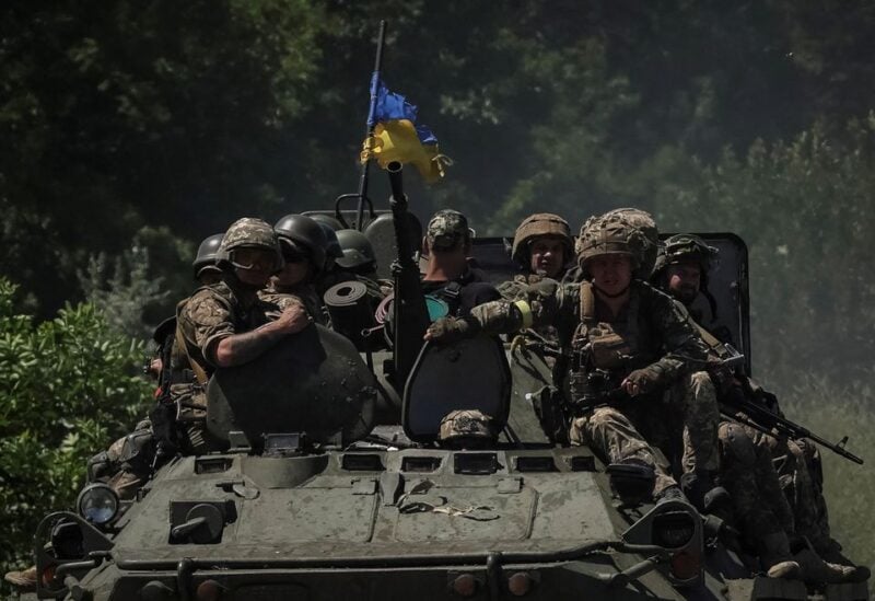 Ukrainian service members ride an Armoured Personnel Carrier (APC), in Donetsk region, amid Russia's attack on Ukraine July 7, 2022. REUTERS/Gleb Garanich