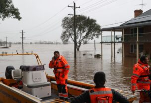State Emergency Service (SES) personnel prepare to deploy as floodwaters submerge residential areas following heavy rains in the Windsor suburb of Sydney, Australia, July 5, 2022. REUTERS/Loren Elliott