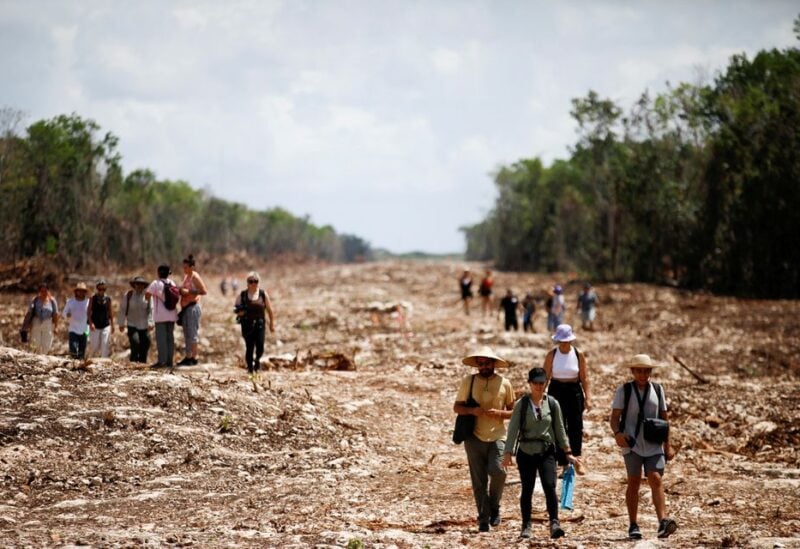Activists and locals march as they protest at one of the construction sections of the Mayan train due to the environmental impact and the destruction of the jungle caused by the project, in Playa del Carmen, Mexico April 23, 2022. REUTERS/Raquel Cunha