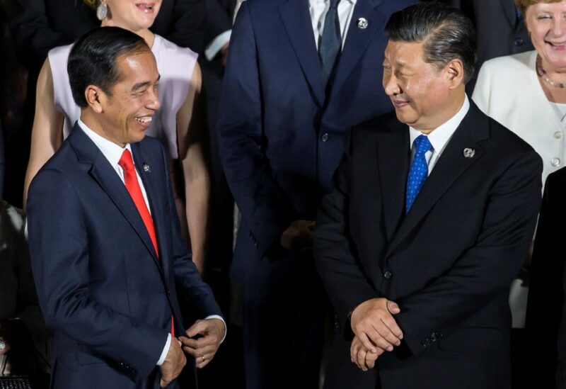 Indonesia's President Joko Widodo speaks to China's President Xi Jinping during a family photo session in front of Osaka Castle at the G-20 summit, in Osaka, Japan June 28, 2019 Tomohiro Ohsumi/Pool via REUTERS