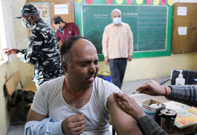 A man reacts as he receives a dose of the COVISHIELD vaccine, against the coronavirus disease (COVID-19), manufactured by Serum Institute of India, at a vaccination centre in New Delhi, India, January 12, 2022. REUTERS/Anushree Fadnavis/File Photo