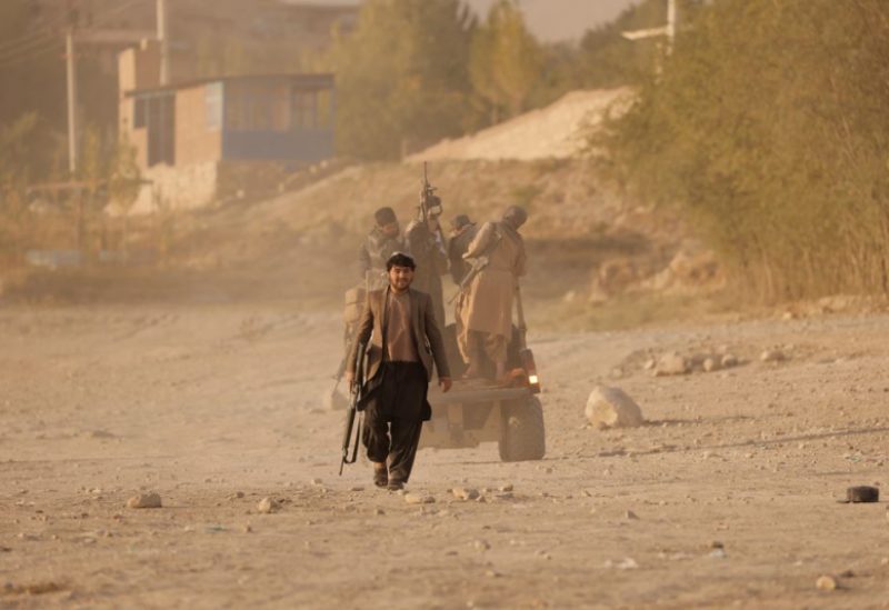 A Taliban fighter walks as he and others take a day off to visit the amusement park at Kabul's Qargha reservoir, at the outskirts of Kabul, Afghanistan October 8, 2021. Picture taken October 8, 2021. REUTERS/Jorge Silva