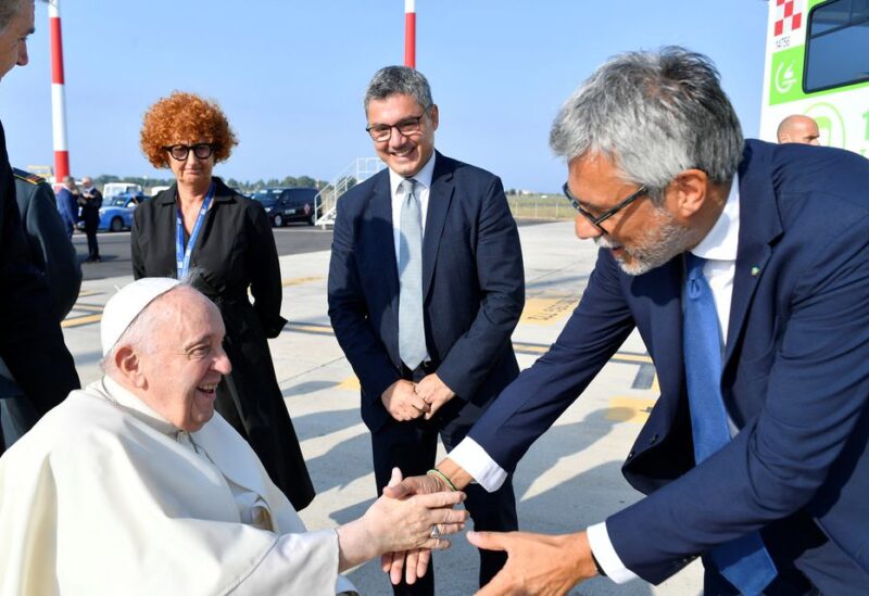 Pope Francis greets a person as he arrives to board a plane for his visit to Canada, at Rome–Fiumicino International Airport in Fiumicino, Italy July 24, 2022. Vatican Media/Handout via REUTERS