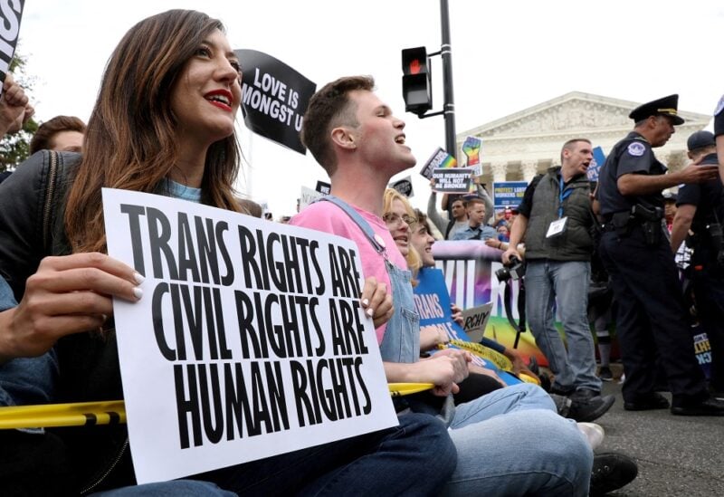 LGBTQ activists and supporters block the street outside the U.S. Supreme Court as it hears arguments in a major LGBT rights case on whether a federal anti-discrimination law that prohibits workplace discrimination on the basis of sex covers gay and transgender employees in Washington, U.S. October 8, 2019. REUTERS/Jonathan Ernst/File Photo