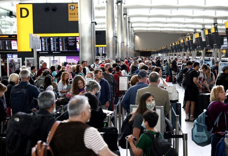 Passengers queue inside the departures terminal of Terminal 2 at Heathrow Airport in London, Britain, June 27, 2022. REUTERS/Henry Nicholls/File Photo