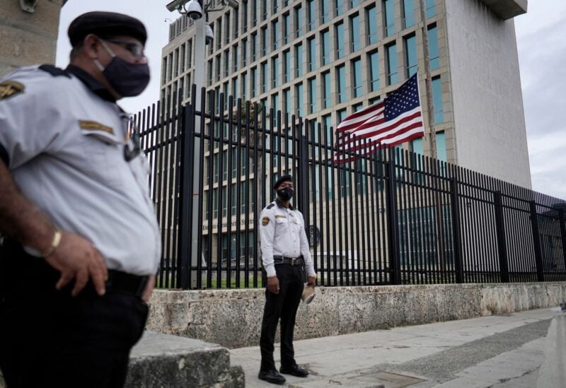 The U.S. flag flies next to security guarding the U.S. embassy in Havana, Cuba, January 12, 2021. REUTERS/Alexandre Meneghini