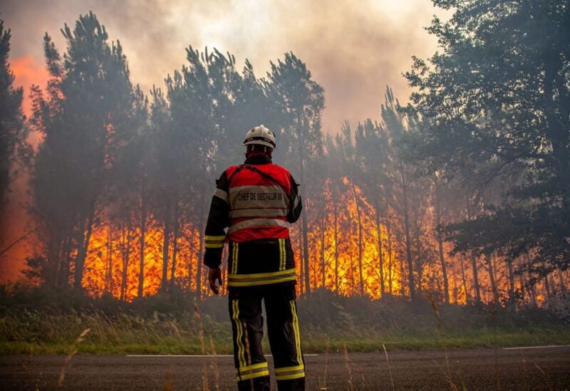 A firefighter works to contain a fire that broke out near Landiras, as wildfires continue to spread in the Gironde region of southwestern France, in this handout picture taken July 15, 2022 and obtained from the fire brigade of the Gironde region (SDIS 33) on July 16, 2022. SDIS 33/Handout via REUTERS