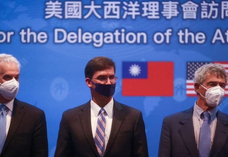 Former U.S. Defense Secretary Mark Esper takes a group photo during a press conference in Taipei, Taiwan