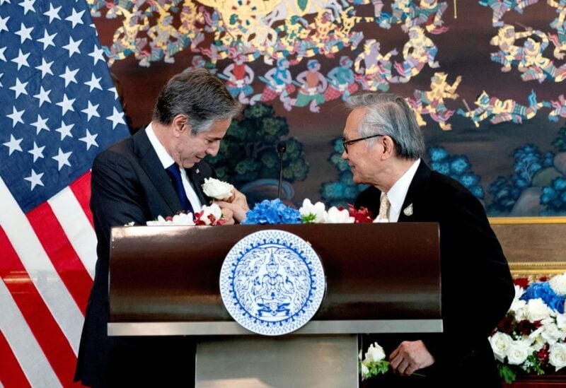 Thailand's Foreign Minister Don Pramudwinai places a flower on the jacket of U.S. Secretary of State Antony Blinken following remarks to the press after a Memorandum of Understanding signing ceremony at the Thai Ministry of Foreign Affairs in Bangkok, Thailand, July 10, 2022. Stefani Reynolds/Pool via REUTERS