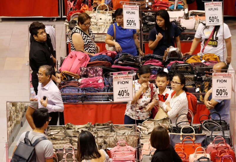 People shop for bags in Singapore April 24, 2017. REUTERS/Edgar Su