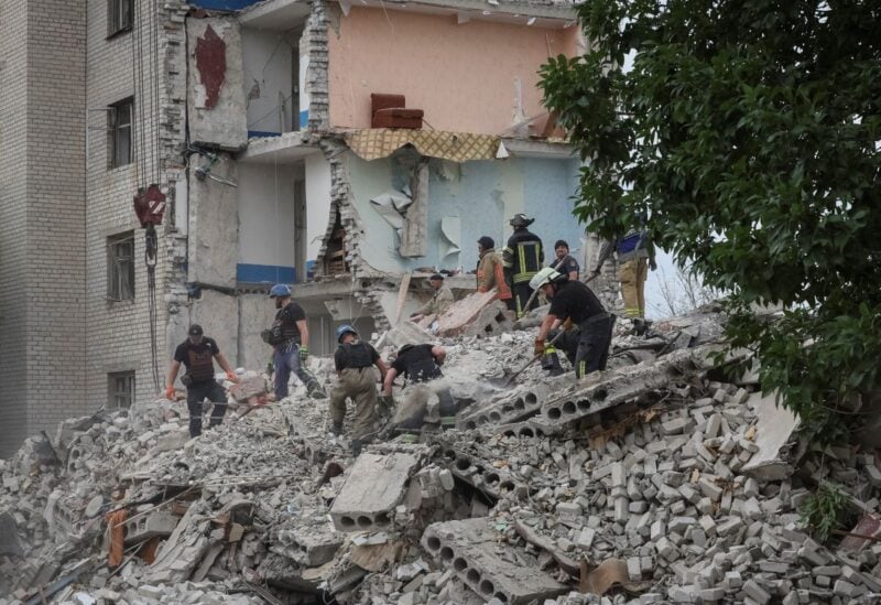 Rescuers work at a residential building damaged by a Russian military strike, amid Russia's invasion on Ukraine, in the town of Chasiv Yar, in Donetsk region, Ukraine July 10, 2022. REUTERS/Gleb Garanich