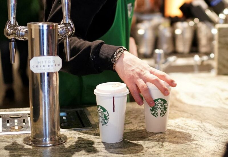 A barista serves beverages in single-use cups inside a Starbucks in London, Britain, March 6, 2020. REUTERS/Henry Nicholls