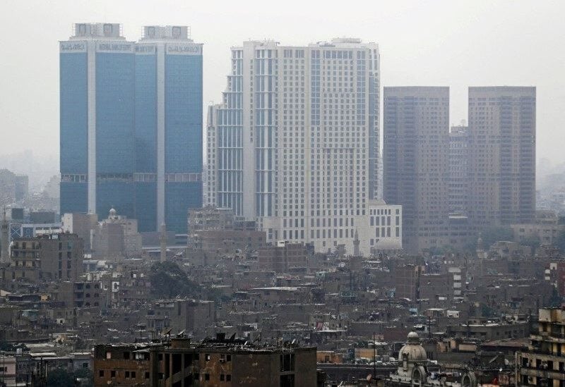 National Bank of Egypt head offices, the St. Regis Cairo hotel and Hilton Cairo World Trade Center Residences are seen towering above residential buildings. REUTERS/Mohamed Abd El Ghany.