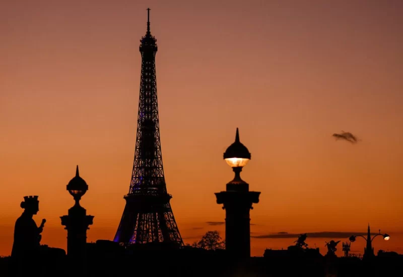 The Eiffel Tower is seen at sunset in Paris